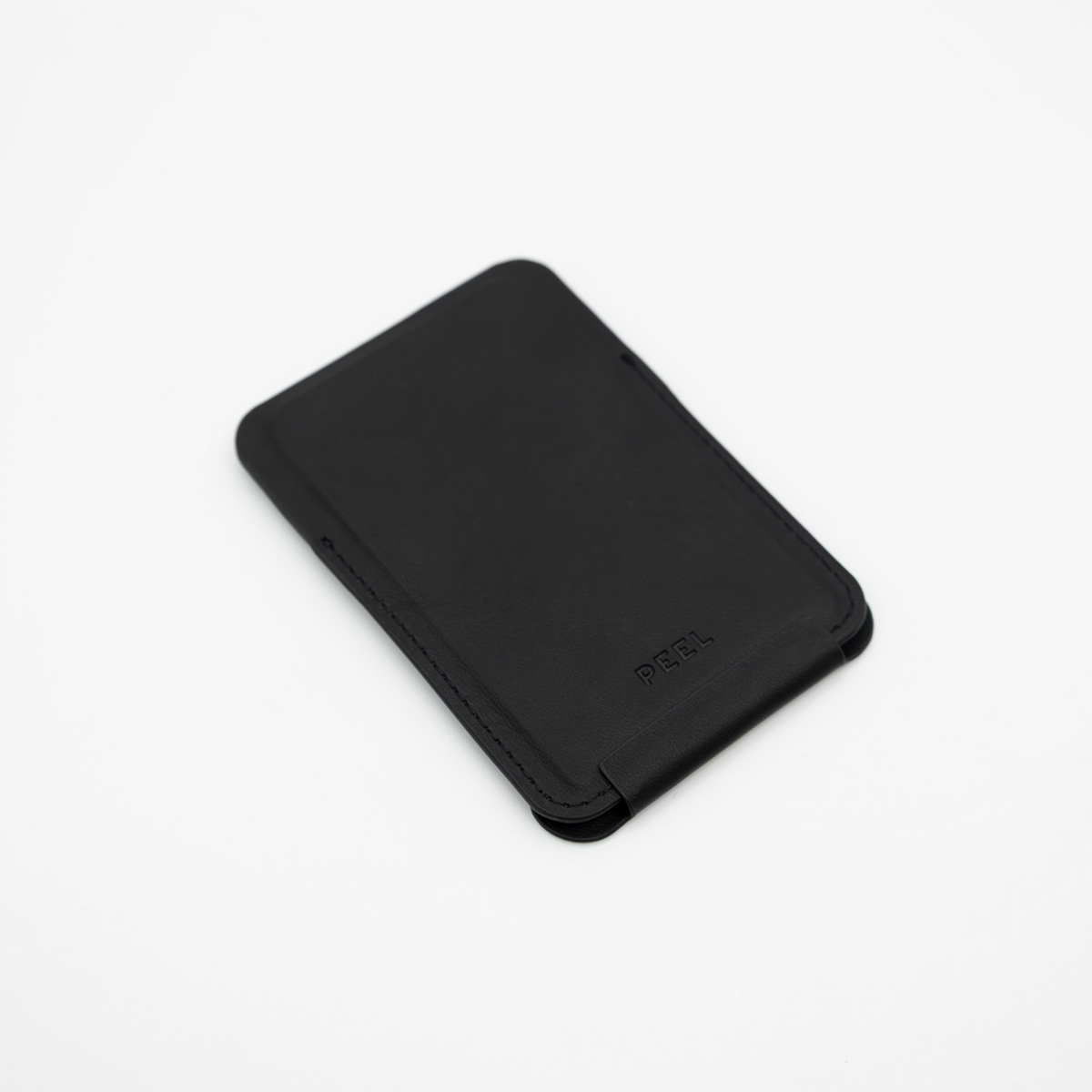 Black Peel Magnetic Wallet Stand lying flat with the stand folded closed, showing its slim profile
