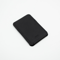 Black Peel Magnetic Wallet Stand lying flat with the stand folded closed, showing its slim profile